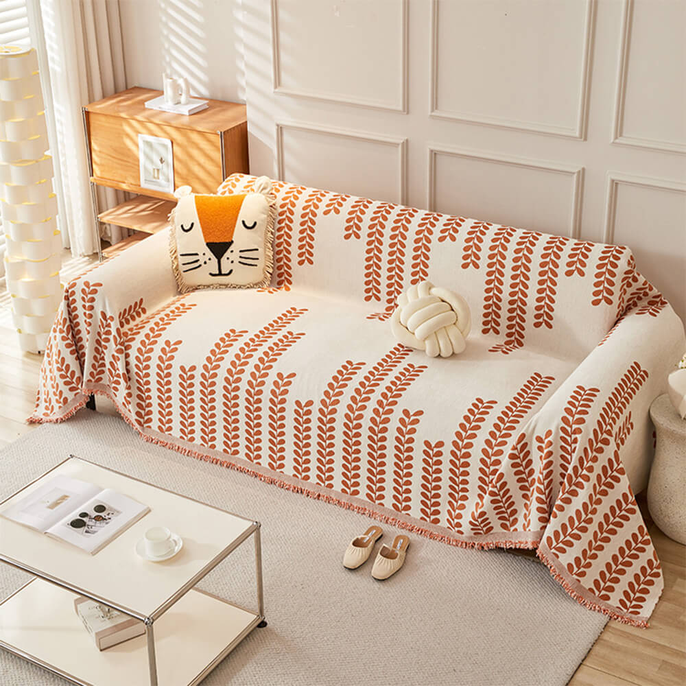 葉とフリンジの模様のソファカバー – 優雅さと快適さ 